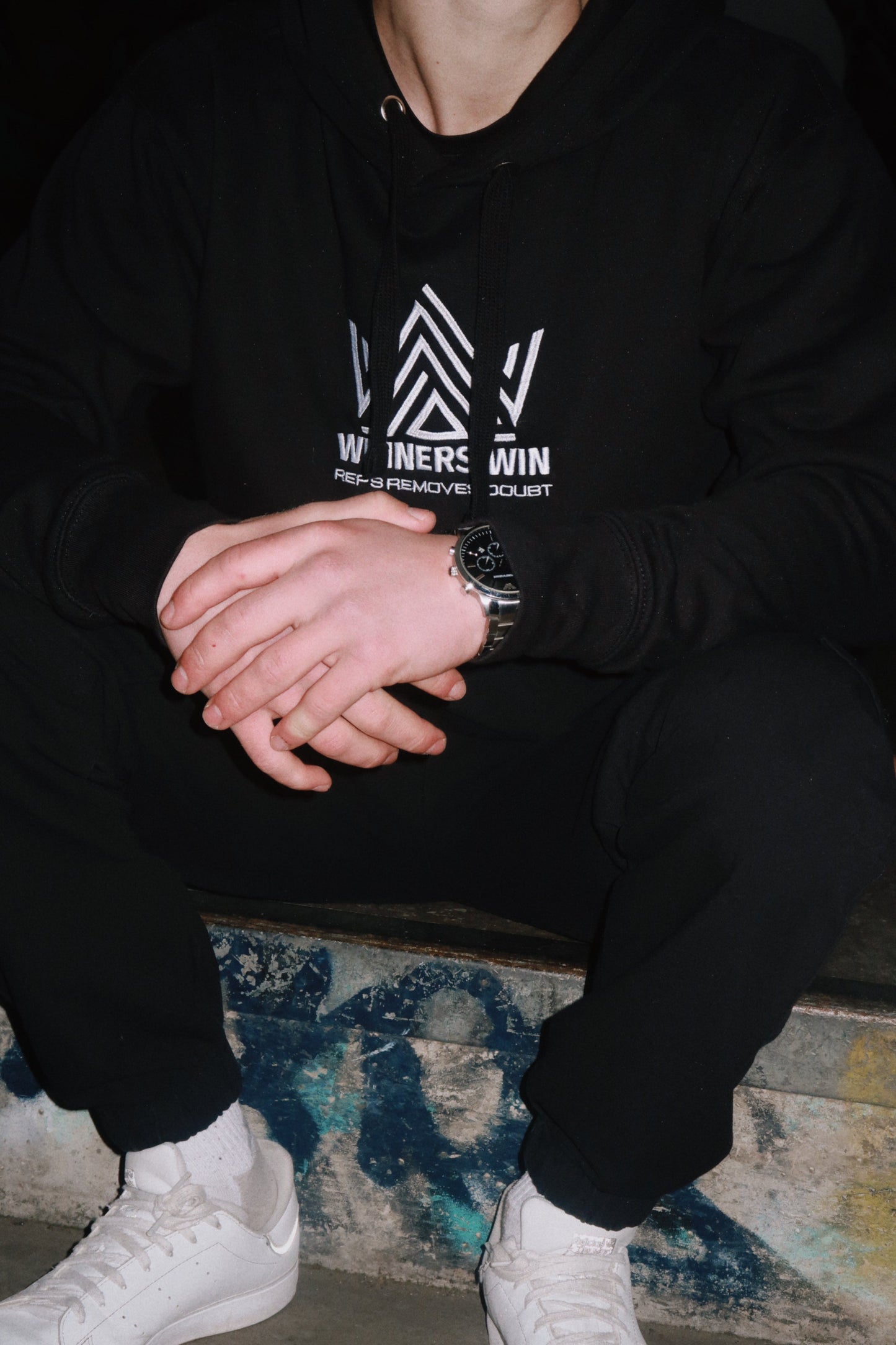 Winners Win Reps Removes Doubt hoodie in black being worn at a skate park in Belfast
