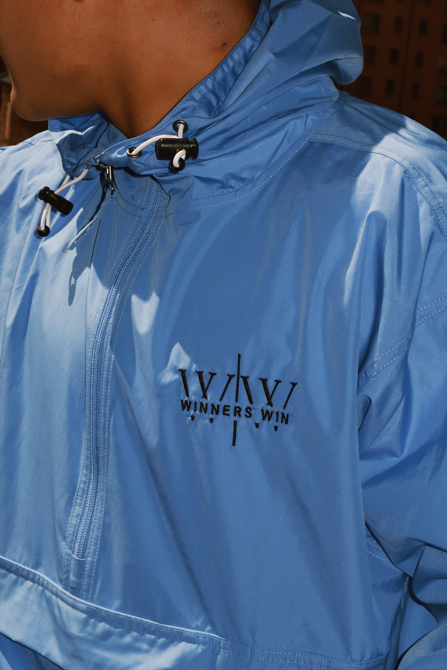 Close up of the light blue winners win running jacket