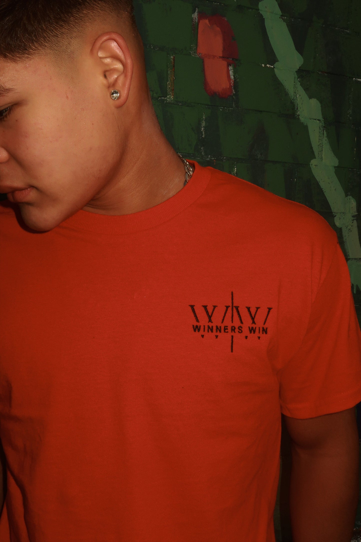Winners Win red cotton t-shirt being worn at a photoshoot in Belfast