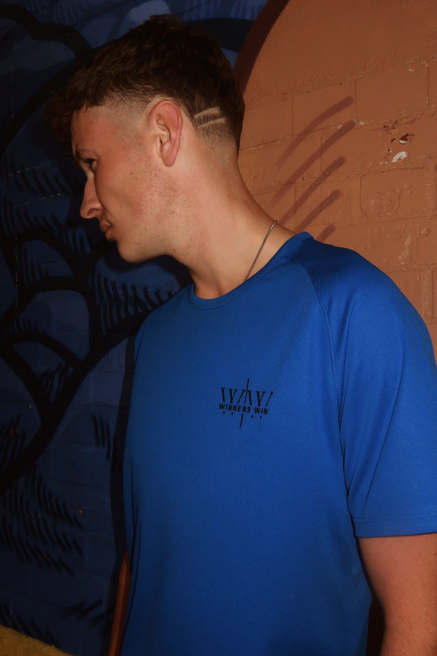 Winners Win Dark blue performance t-dhirt being worn at a photoshoot in belfast