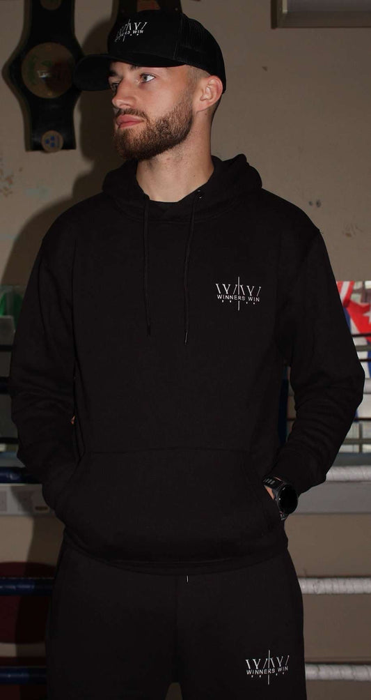 Professional John Boyd wearing the full Winners Win tracksuit in black with the white Winners Win logo