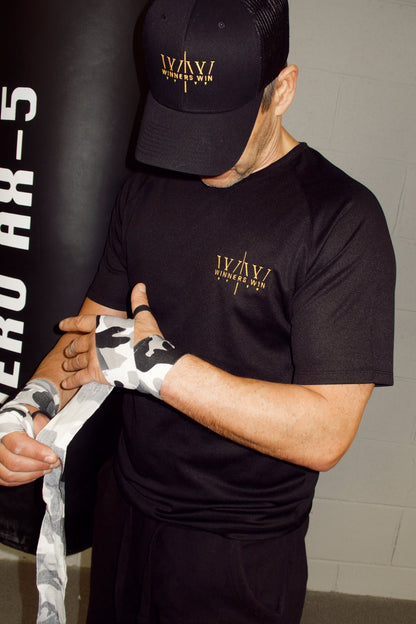 Winners Win black hat being wore by a boxer while putting his hand wraps on