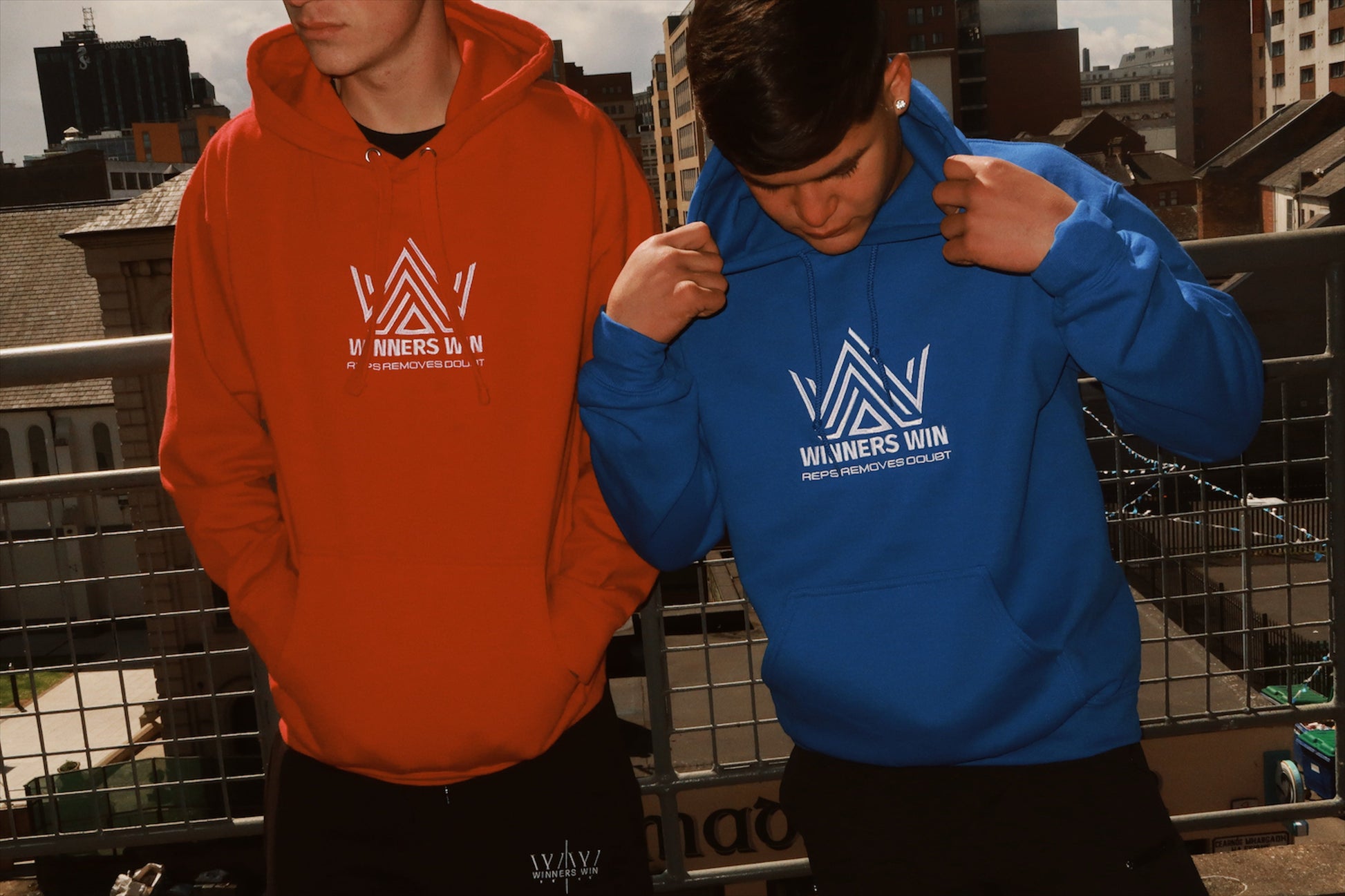 The blue and the red reps removes doubt hoodies being worn at a photoshoot in Belfast