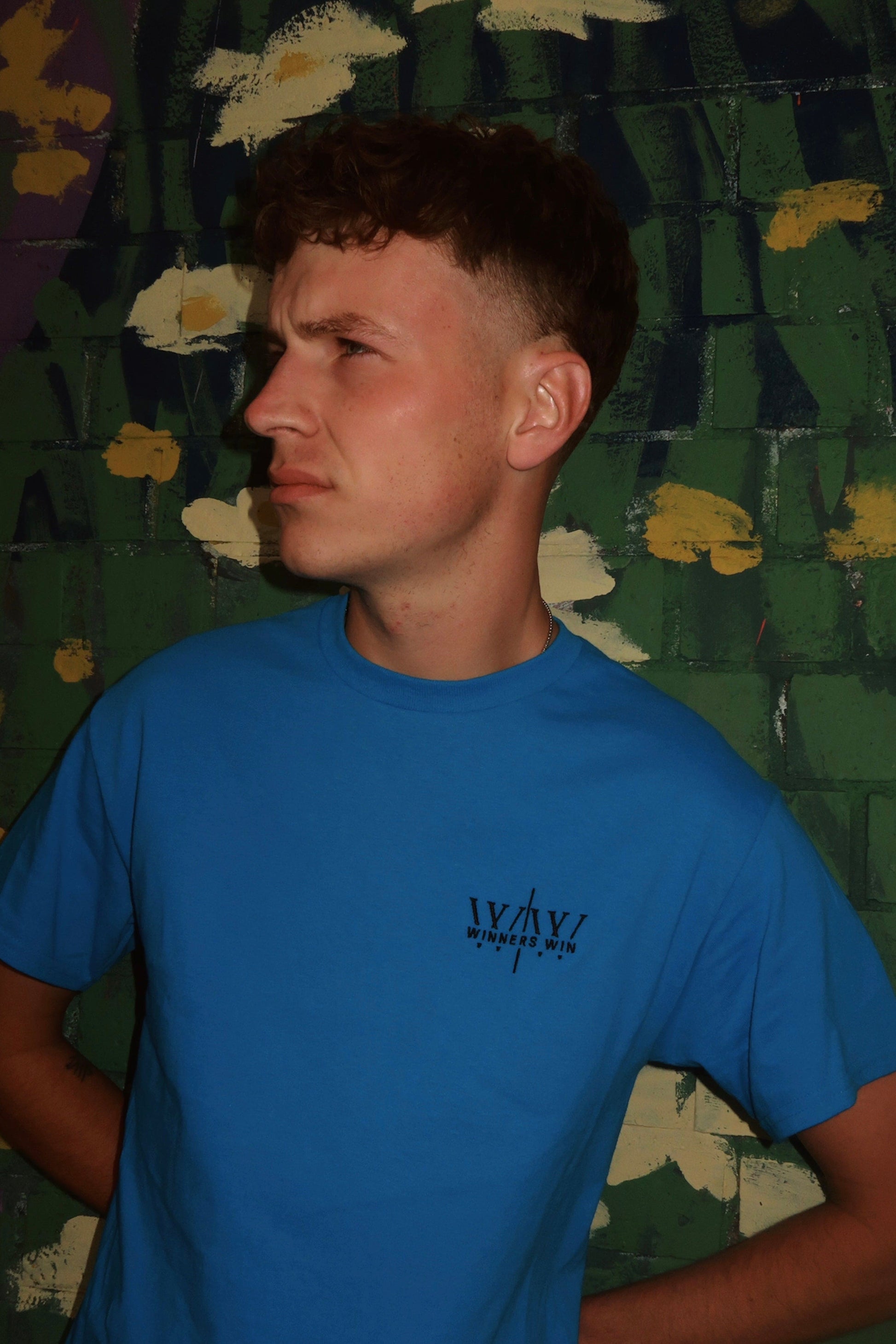 Blue Winners Win T-Shirt being worn at a photoshoot in Belfast