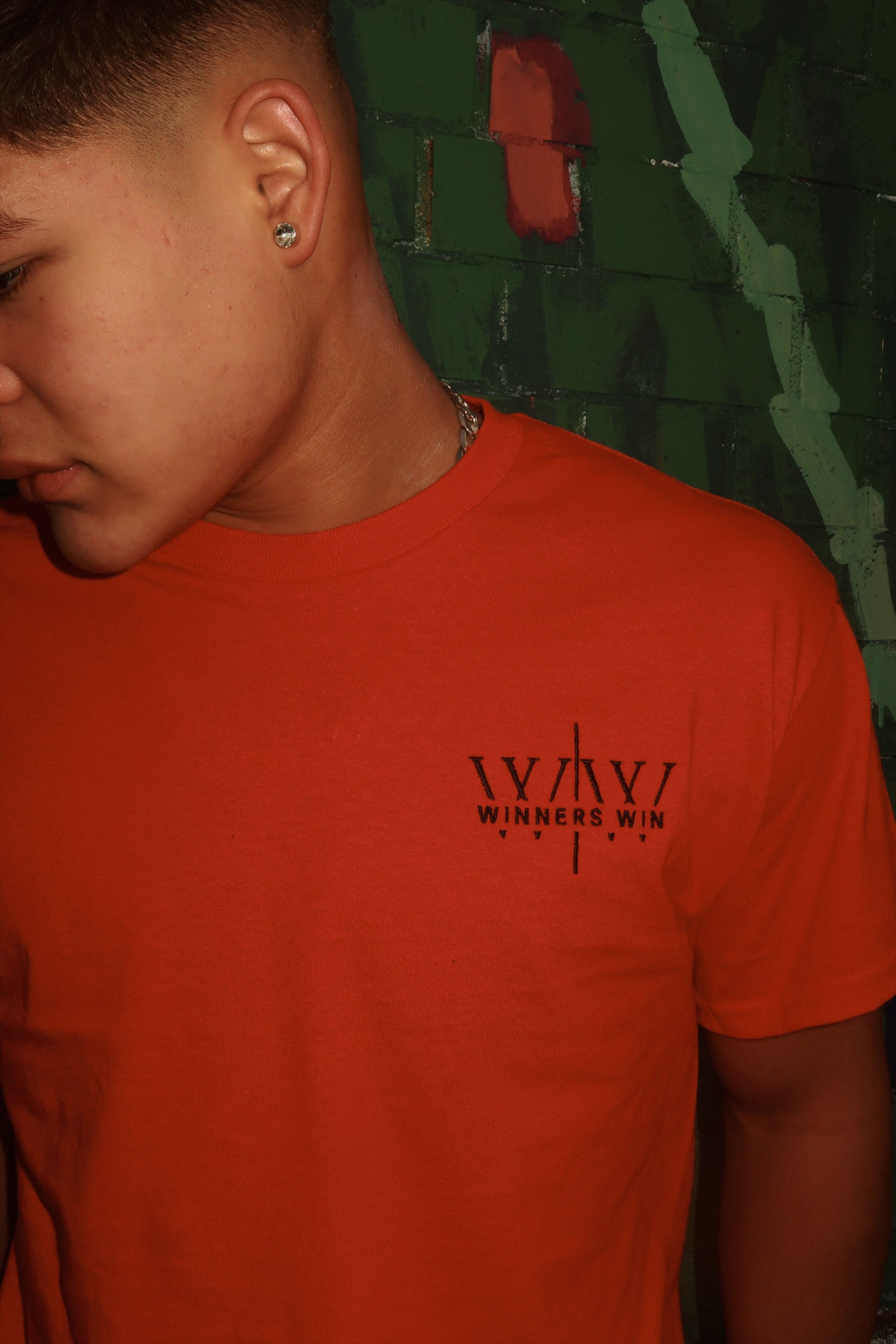Winners Win red cotton t-shirt being worn at a photoshoot in Belfast
